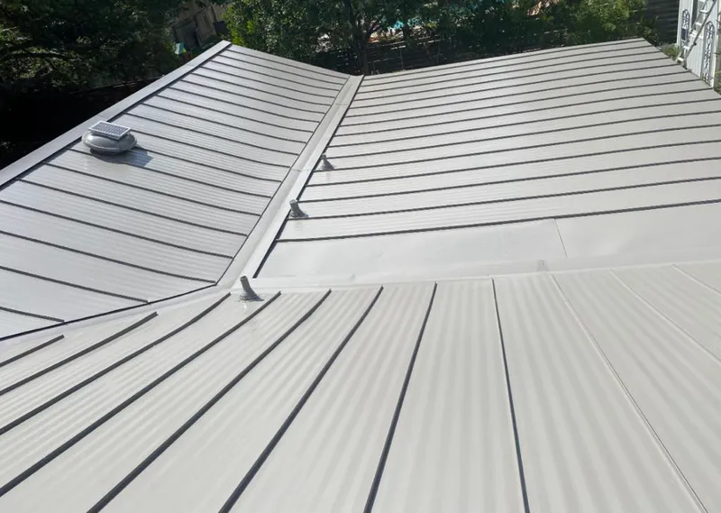 Solar attic fan installed on a metal roof for Roof Ventilation in Newcastle